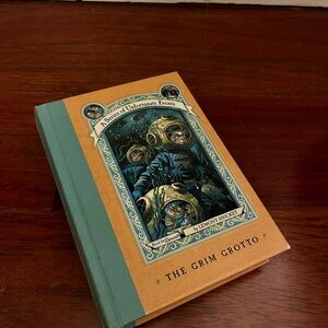 The Grim Grotto Hardcover - Orange/Turquoise